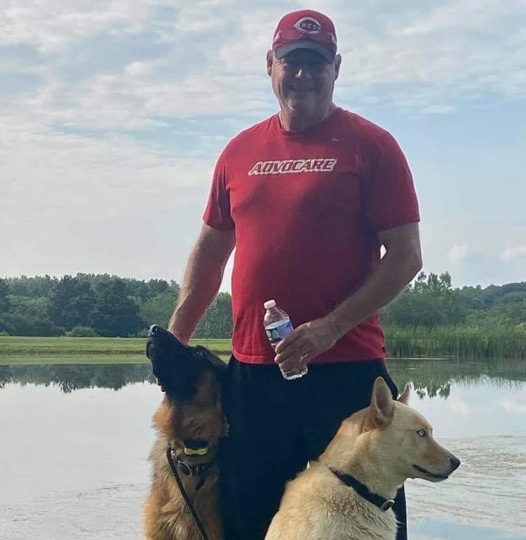 Tony Tipton with his dogs by the lake