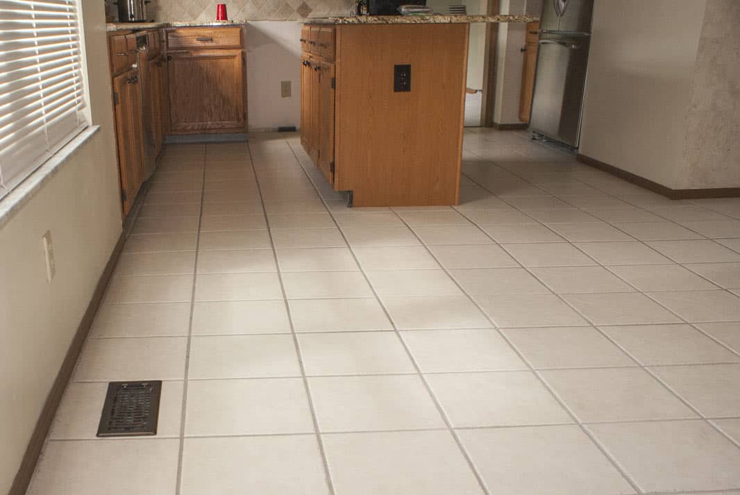 Kitchen with old cream ceramic tile before LVT installation